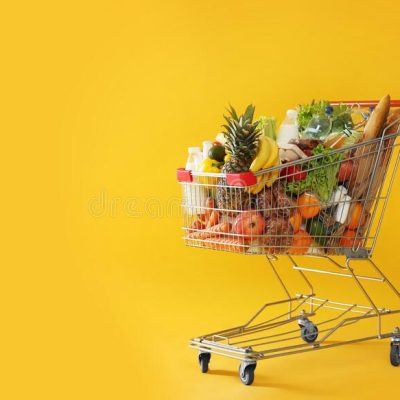 shopping-cart-full-groceries-yellow-background-space-text-219766258